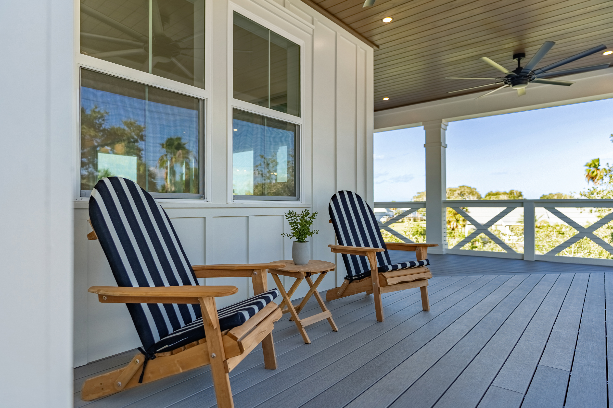 Vacation rental - covered porch with Adirondack chairs and waterfront view