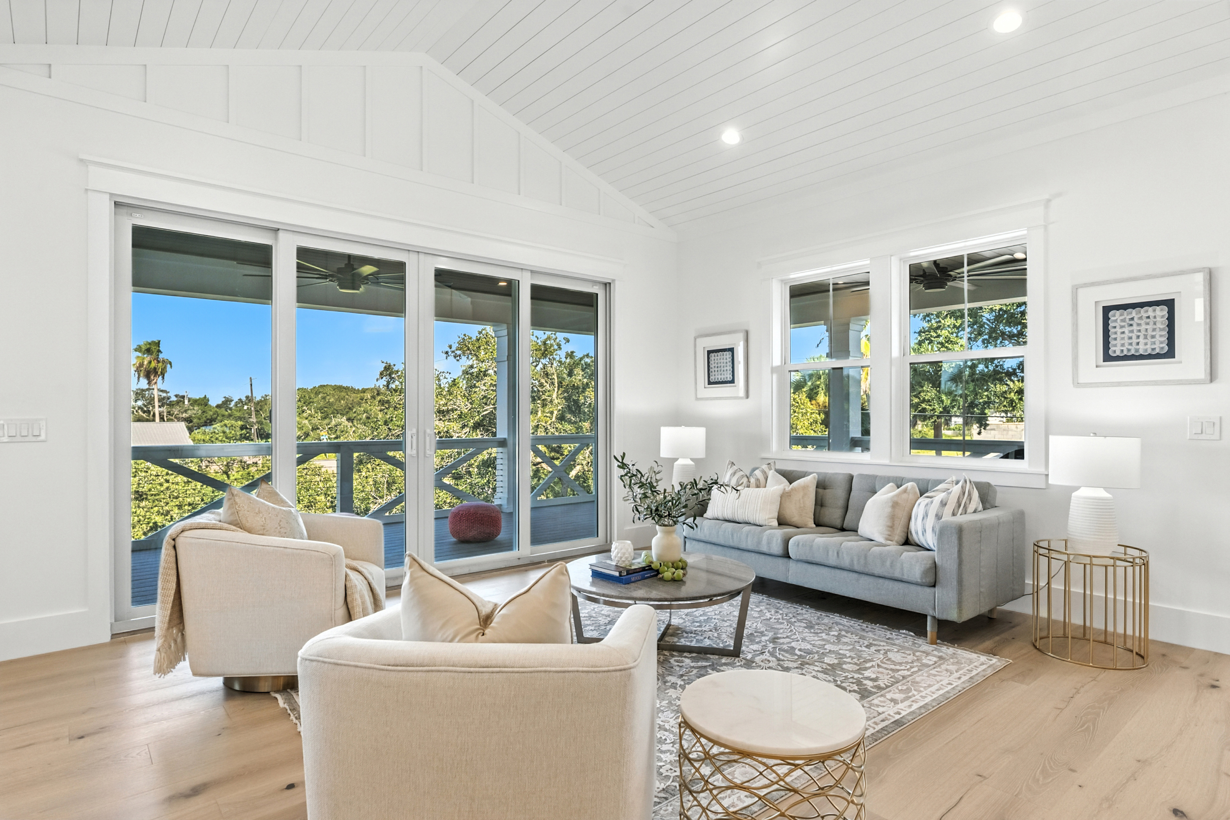 Occupied staging - living room with gray sofa and water view