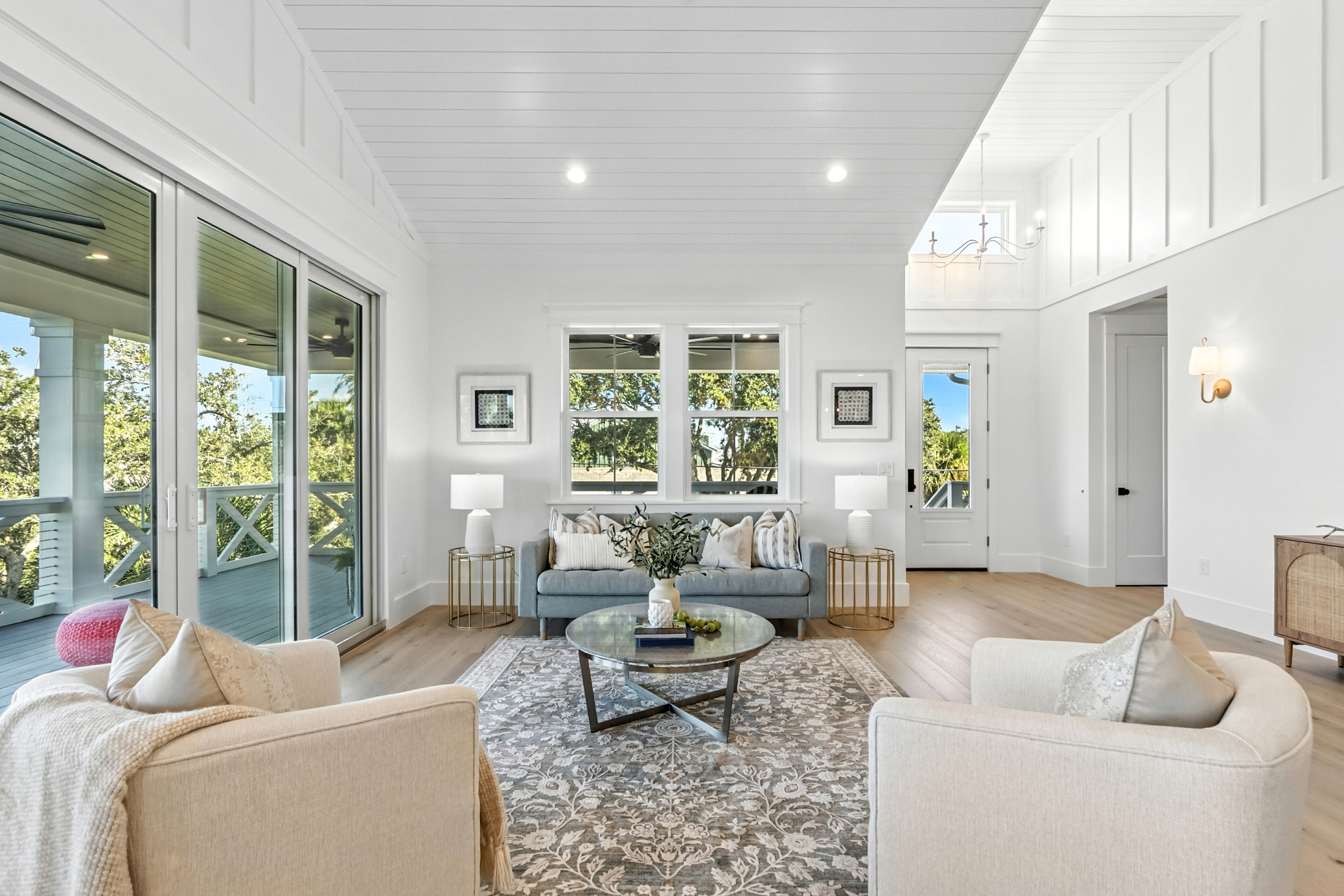 Occupied staging - living room with vaulted shiplap ceiling and blue sofa